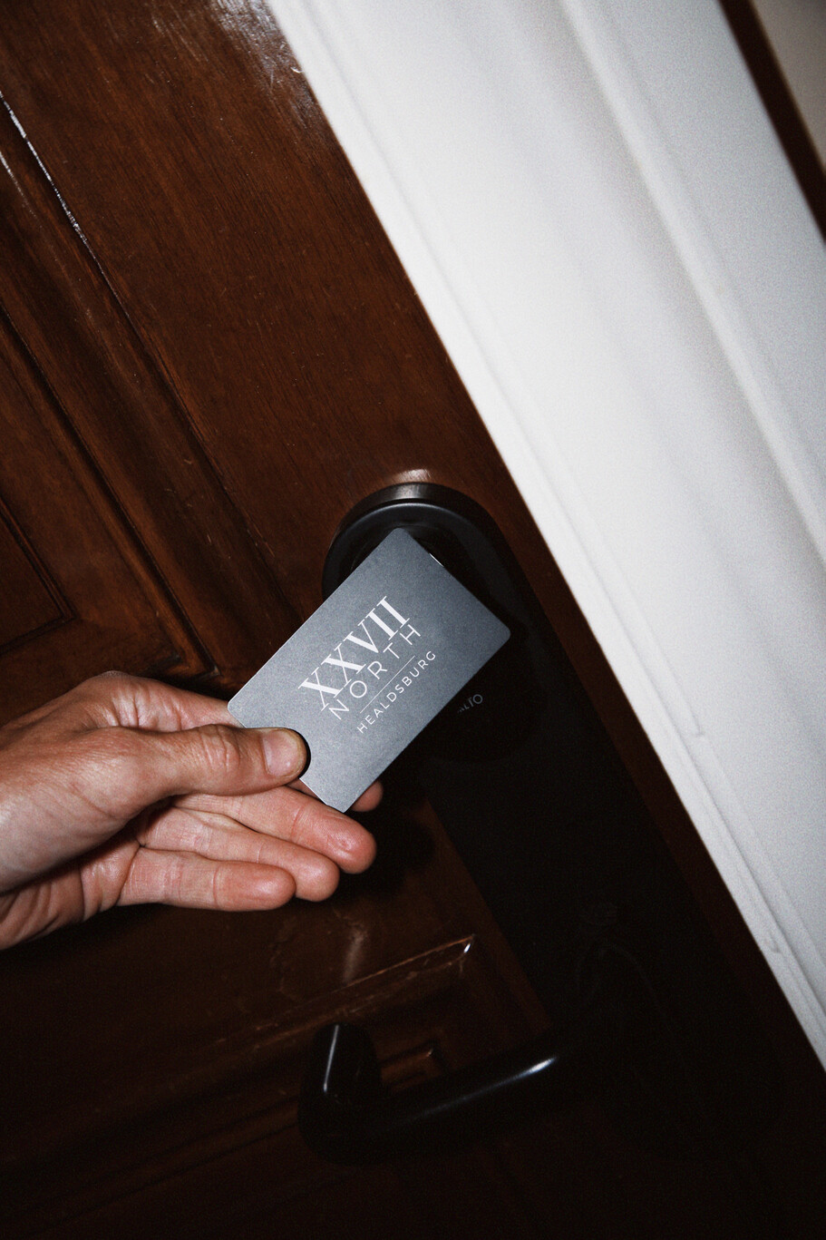 a person holding a card in front of a door